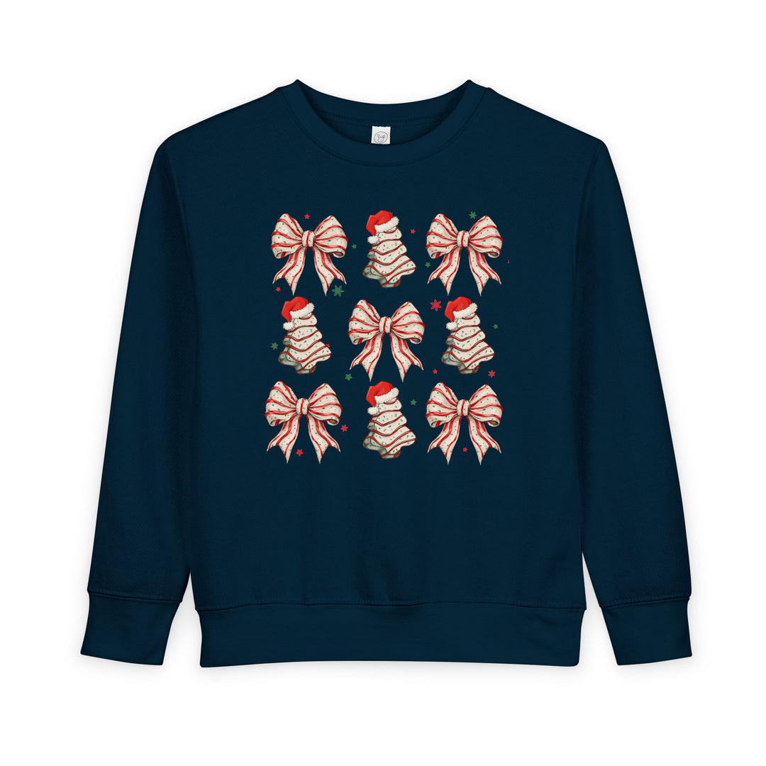 Cookies and Bows Toddler Crew: Navy-blue sweatshirt with a 3x3 grid of candy-cane bows and Christmas trees, featuring durable ribbed cuffs and waistband.