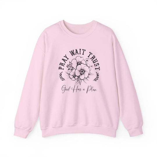 Pray Wait Trust Crew: Pink sweatshirt featuring a black and white flower design, long sleeves, ribbed knit collar, and a comfortable, loose fit.