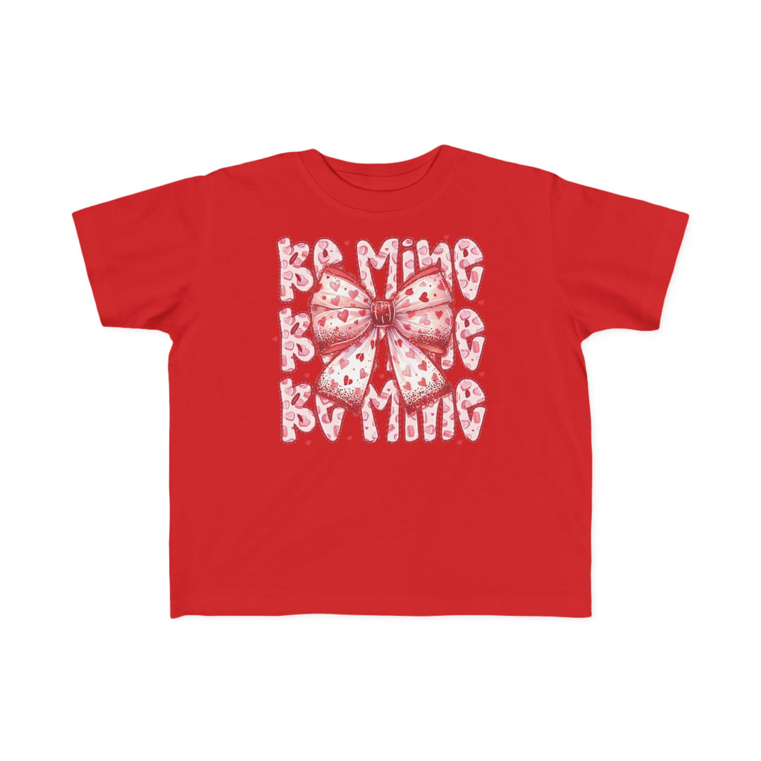 Be Mine Toddler Tee featuring a large stylized bow with heart motifs and BE MINE text, ideal for Valentine's, crafted for toddler comfort.