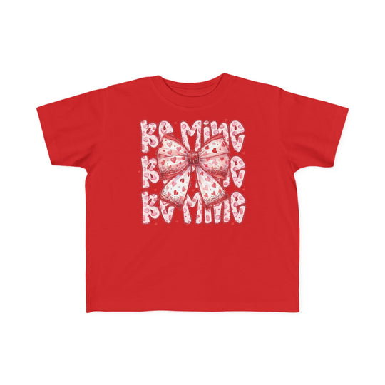 Be Mine Toddler Tee featuring a large stylized bow with heart motifs and BE MINE text, ideal for Valentine's, crafted for toddler comfort.