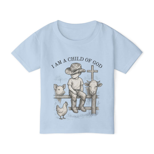 Toddler tee displaying I AM A CHILD OF GOD with a vintage-style sketch of a boy, cowboy hat, animals, and cross, epitomizing Faith Family Designs' charming graphic apparel.