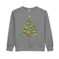 Dino Tree Toddler Crew sweatshirt features cartoon dinosaurs forming a Christmas tree, adorned with lights, ornaments, and Santa hats, offering festive charm and comfort.