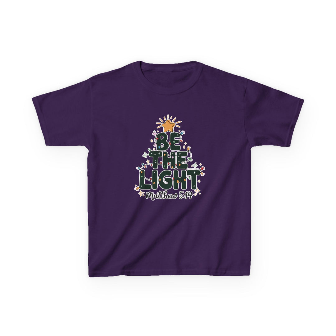 Be the Light Kids Tee featuring a Christmas tree design with BE THE LIGHT in green, colorful lights, and Matthew 5:14 reference on purple fabric.