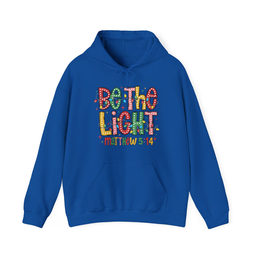Royal-blue hoodie with Be The Light graphic and Matthew 5:14 text, featuring a cozy fit and kangaroo pocket. Ideal for cold days.