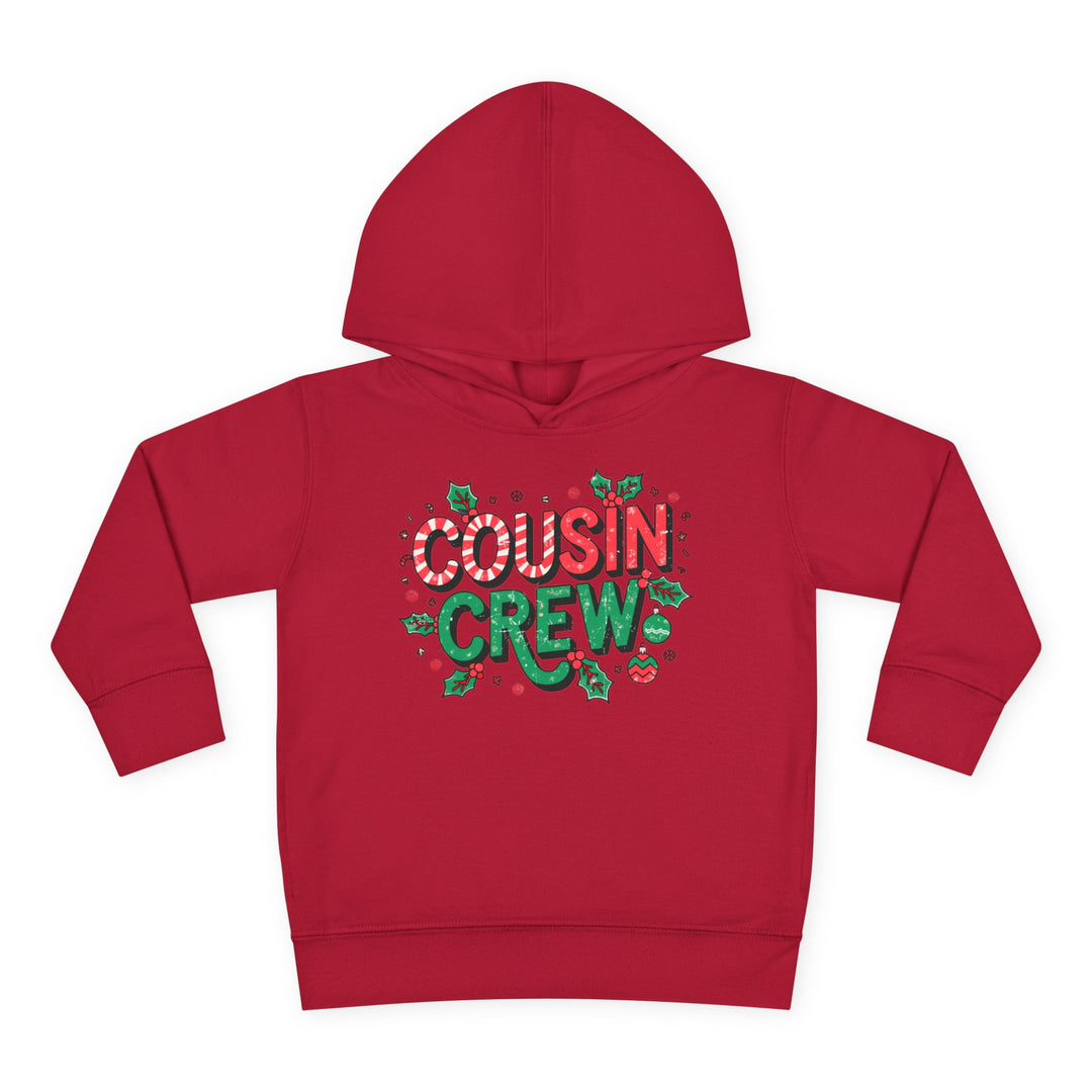 Cousin Crew Christmas Toddler Hoodie with candy-cane style COUSIN and green CREW, adorned with festive holly, snowflakes, and ornaments, featuring durable, cozy design.
