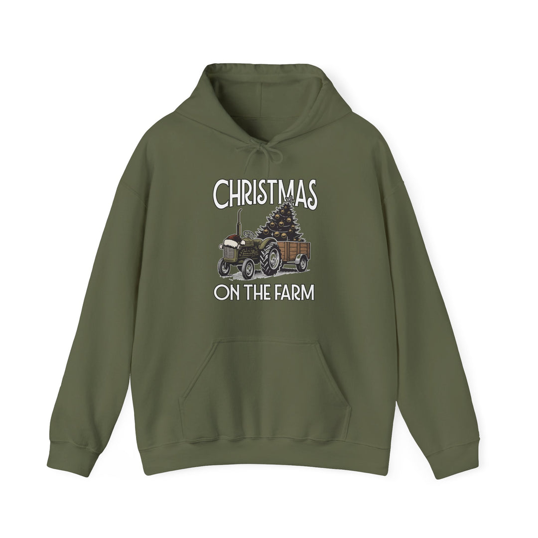 Olive-green Christmas on the Farm hoodie featuring a vintage tractor with a tree, kangaroo pocket, and drawstring hood, offering warmth and style.