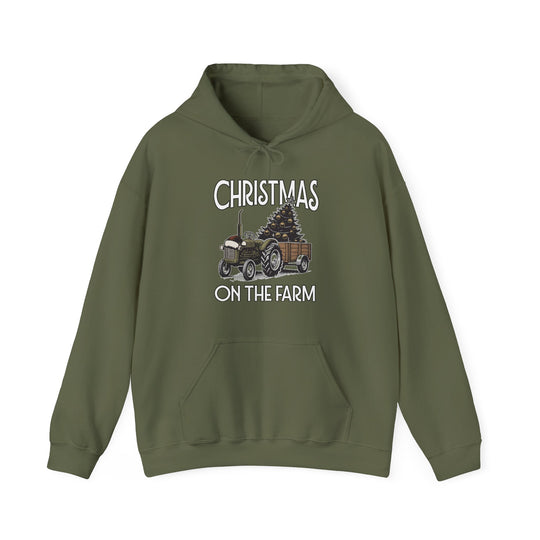 Olive-green Christmas on the Farm hoodie featuring a vintage tractor with a tree, kangaroo pocket, and drawstring hood, offering warmth and style.