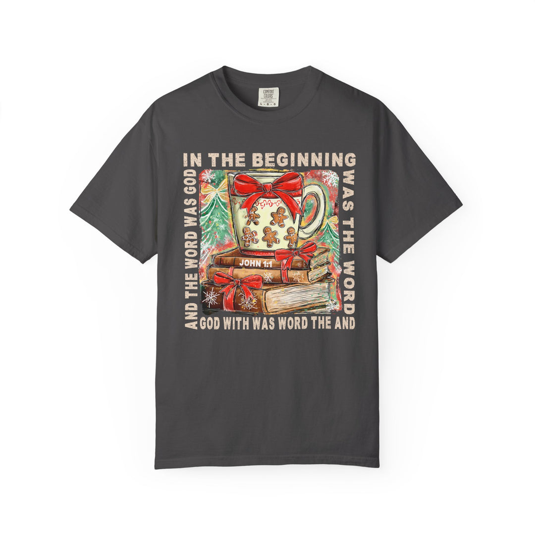 In the Beginning Tee features a Christmas mug and Bible verse graphic on a dark-gray crew-neck T-shirt, ideal for faith-inspired style.