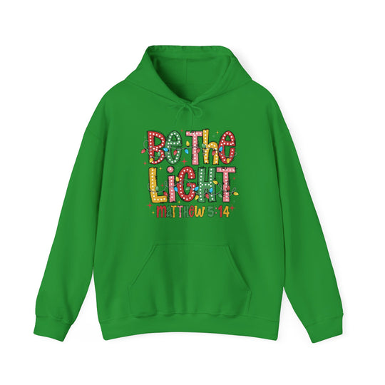 Bright green Be the Light hoodie with holiday string lights graphic, kangaroo pocket, and Matthew 5:14 reference. Cozy blend, unisex fit, designed by Faith Family Designs.