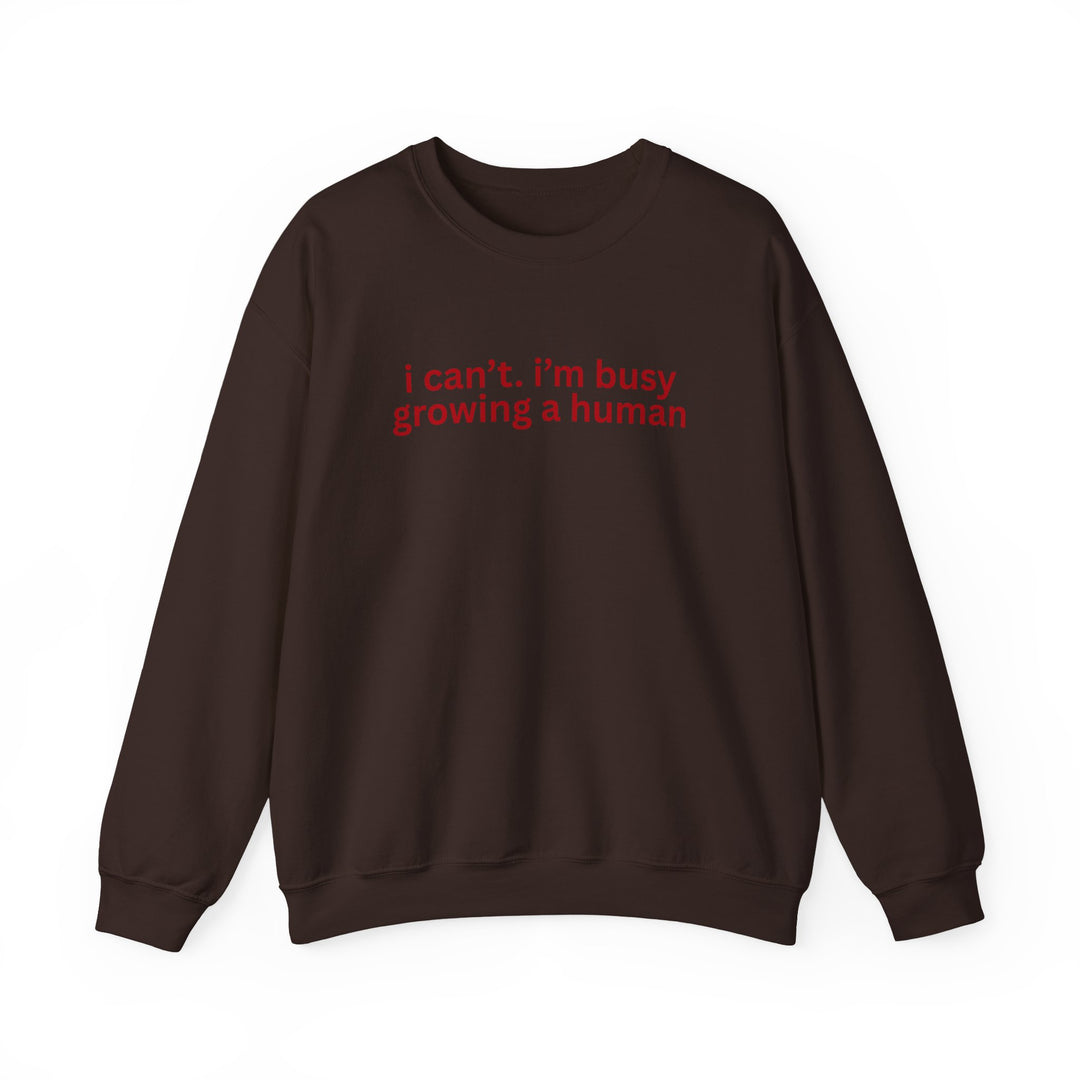 Dark chocolate-brown crewneck sweatshirt with red text: i can’t. i’m busy growing a human. Ideal for comfort, made from a durable polyester-cotton blend.