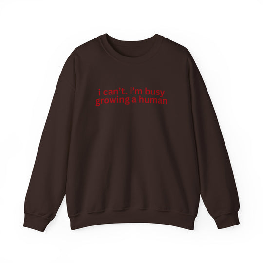 Dark chocolate-brown crewneck sweatshirt with red text: i can’t. i’m busy growing a human. Ideal for comfort, made from a durable polyester-cotton blend.