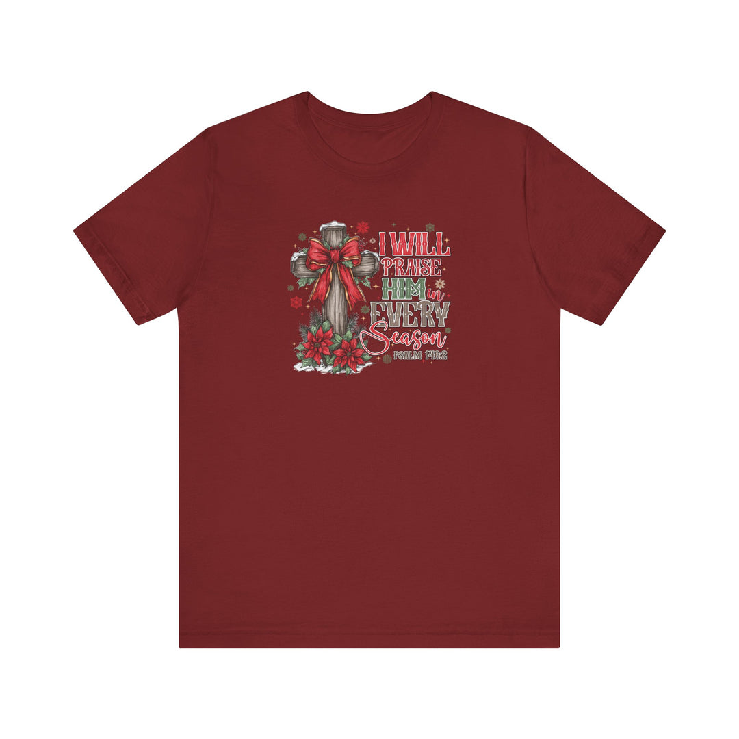 Praise Him in Every Season Tee featuring a wooden cross with poinsettias and snowflakes, expressing faith and style, perfect for Christmas.