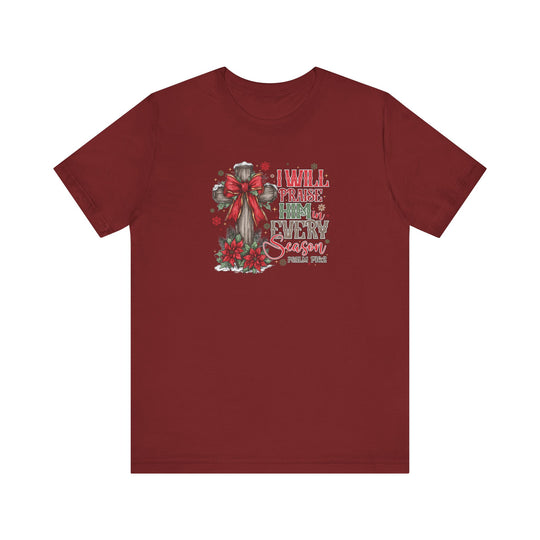 Praise Him in Every Season Tee featuring a wooden cross with poinsettias and snowflakes, expressing faith and style, perfect for Christmas.