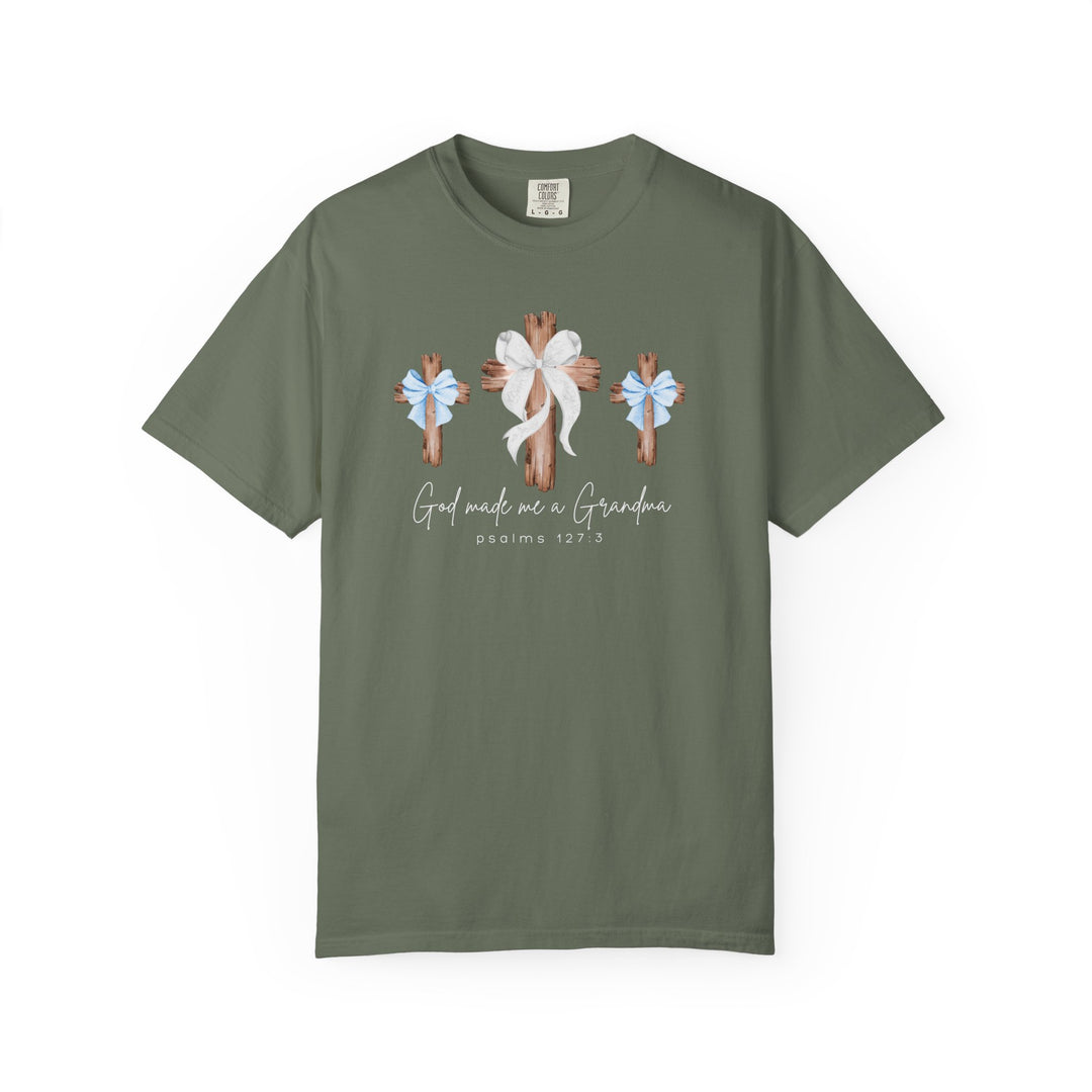 God Made Me a Boy Grandma Tee features rustic wooden crosses with bows and a faith-inspired message, crafted from cozy, garment-dyed cotton for a relaxed fit.