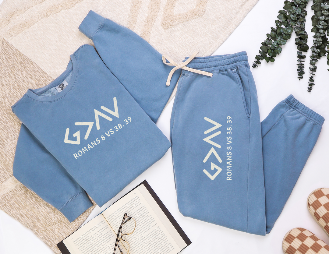 God is Greater Sweatpants on a white surface, showcasing the relaxed fit and vintage vibe from garment-dyed, 100% ring-spun cotton.