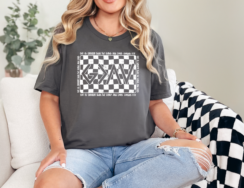 Woman on couch wearing God Highs and Lows Tee, a classic unisex jersey short sleeve tee with ribbed knit collar, showcasing casual comfort and style.