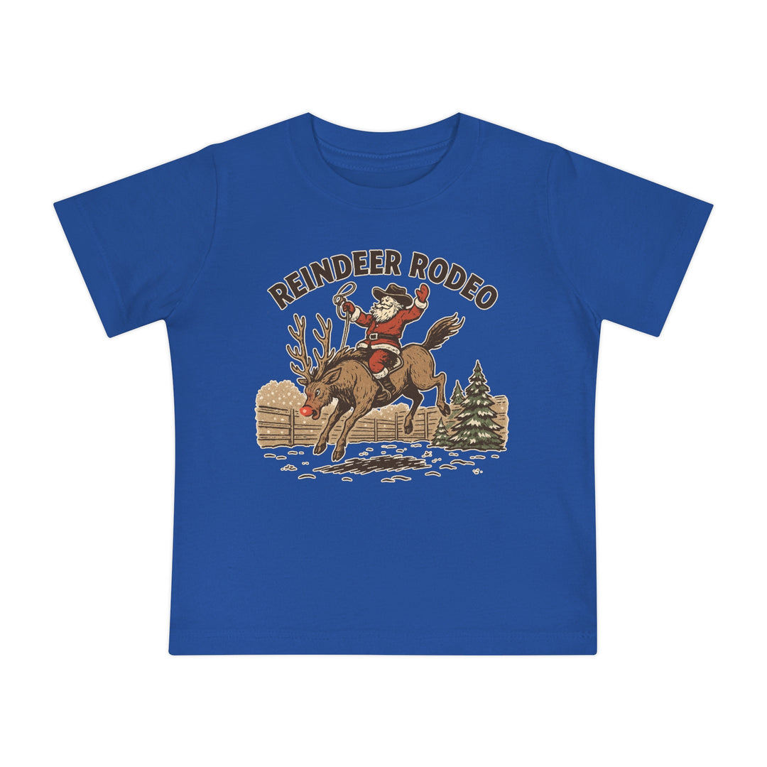Reindeer Rodeo Baby Tee featuring Santa as a cowboy riding a reindeer, perfect for babies. Soft and durable, ideal for festive, playful style.