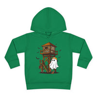 Ghost Hunter Toddler Hoodie: Green hoodie featuring a playful Halloween-hunting scene with a camo-patterned deer stand, bats, and a ghost in an orange cap and boots.