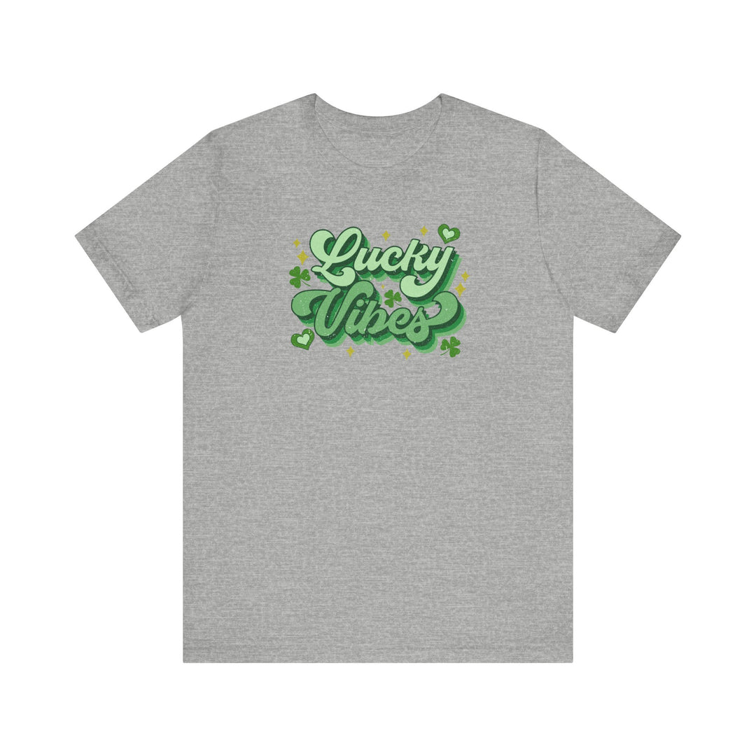 Grey t-shirt featuring green text 'Good Day Lucky Day' with shamrocks and stars, offering a soft, comfortable fit and durable design.