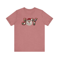 Heathered red-pink Joy Tee with Santa face replacing O, and textured J and Y featuring holly berries. Cozy, unisex fit from Faith Family Designs.