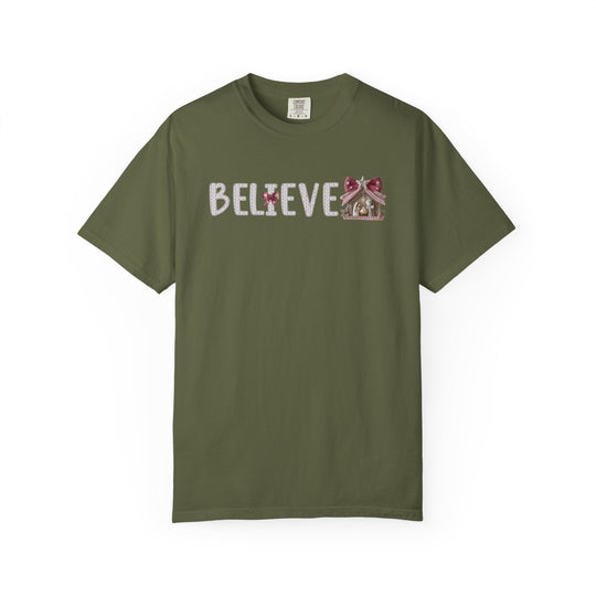 Olive-green Believe Tee with holiday-style 'BELIEVE' print, featuring a candy-cane 'I' and gingerbread-house 'E', offering relaxed fit and comfort.