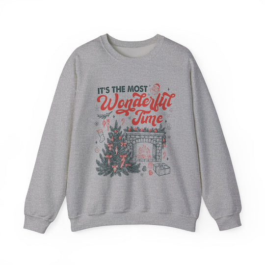 Light-heather-gray crewneck sweatshirt featuring Most Wonderful Time with festive Christmas graphics, including a tree, fireplace, and Santa, designed for cozy holiday comfort.