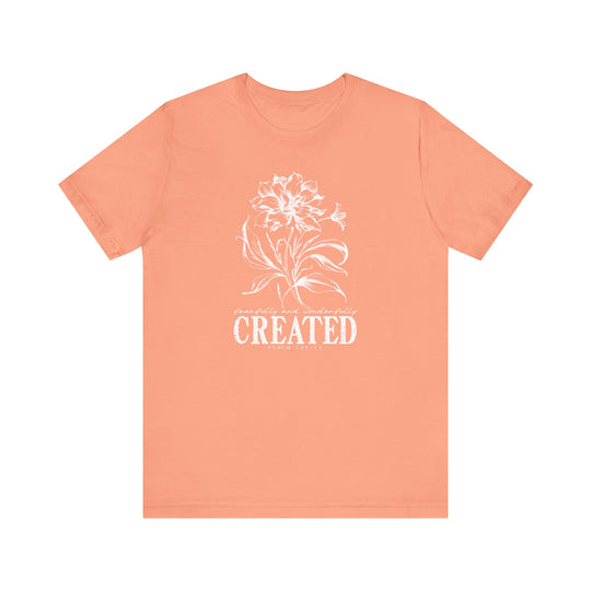 The Created Tee is a unisex jersey short sleeve shirt featuring a classic crew neckline, soft cotton fabric, and ribbed knit collars for lasting comfort and style.