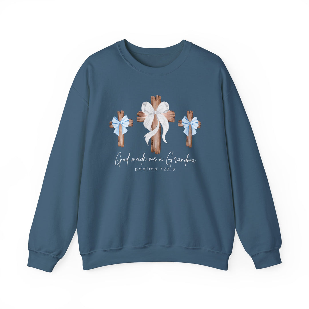 Blue crew-neck sweatshirt featuring three wooden crosses with bows and the phrase “God Made Me a Grandma” in a cozy, unisex heavy blend fabric.