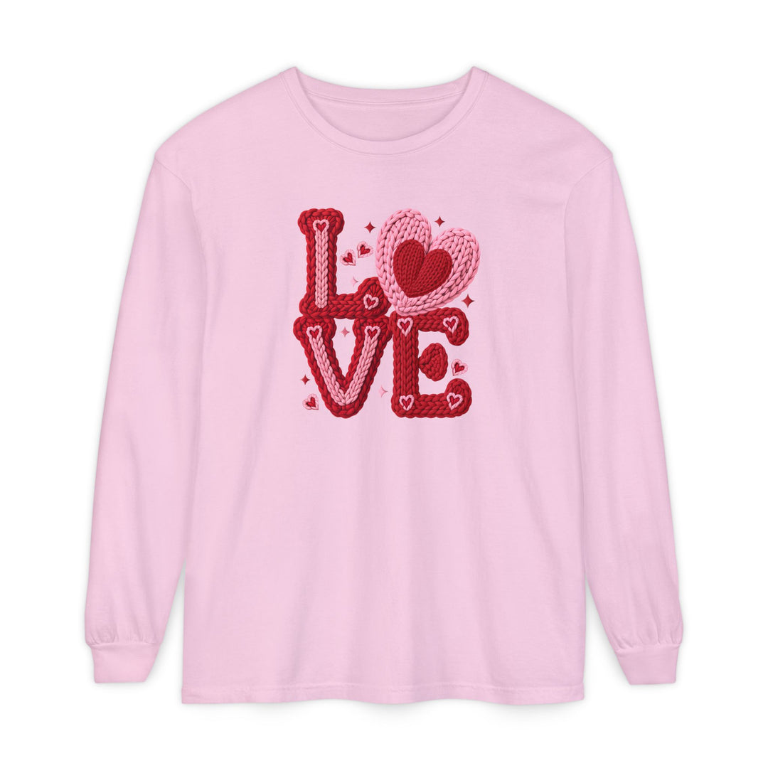 Light pink crewneck shirt featuring LOVE in a chunky, knitted-yarn motif with hearts and sparkles, perfect for a playful, Valentine’s Day-inspired look.