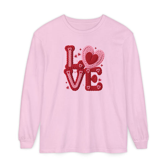 Light pink crewneck shirt featuring LOVE in a chunky, knitted-yarn motif with hearts and sparkles, perfect for a playful, Valentine’s Day-inspired look.