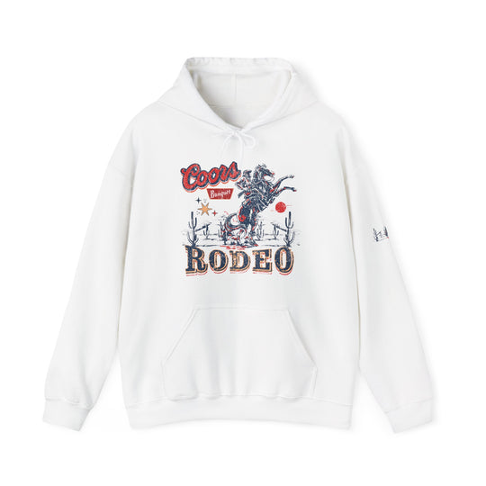A Coors Rodeo Hoodie, a white sweatshirt with a graphic design, unisex heavy blend, cotton-polyester fabric, kangaroo pocket, hood with matching drawstring. Classic fit, tear-away label, medium-heavy fabric.