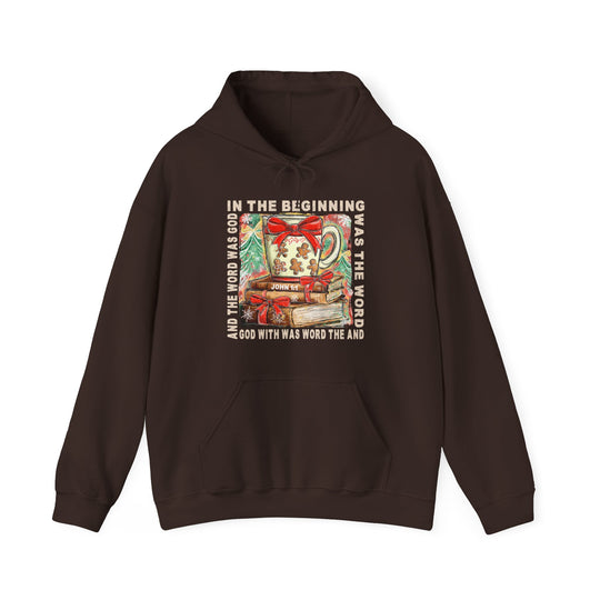 In the Beginning Hoodie featuring a festive mug, books, and John 1:1 verse, crafted for warmth and style with a spacious front pocket.