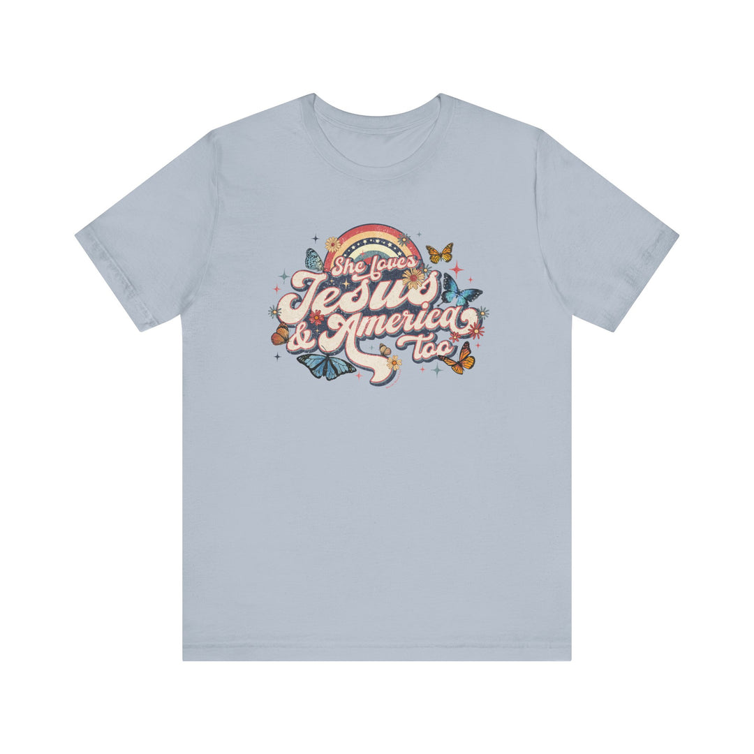 A She Loves Jesus and America Tee: Unisex jersey shirt with a graphic design of butterflies and flowers. 100% Airlume combed cotton, retail fit, tear away label. Sizes XS-3XL. Soft, quality print.