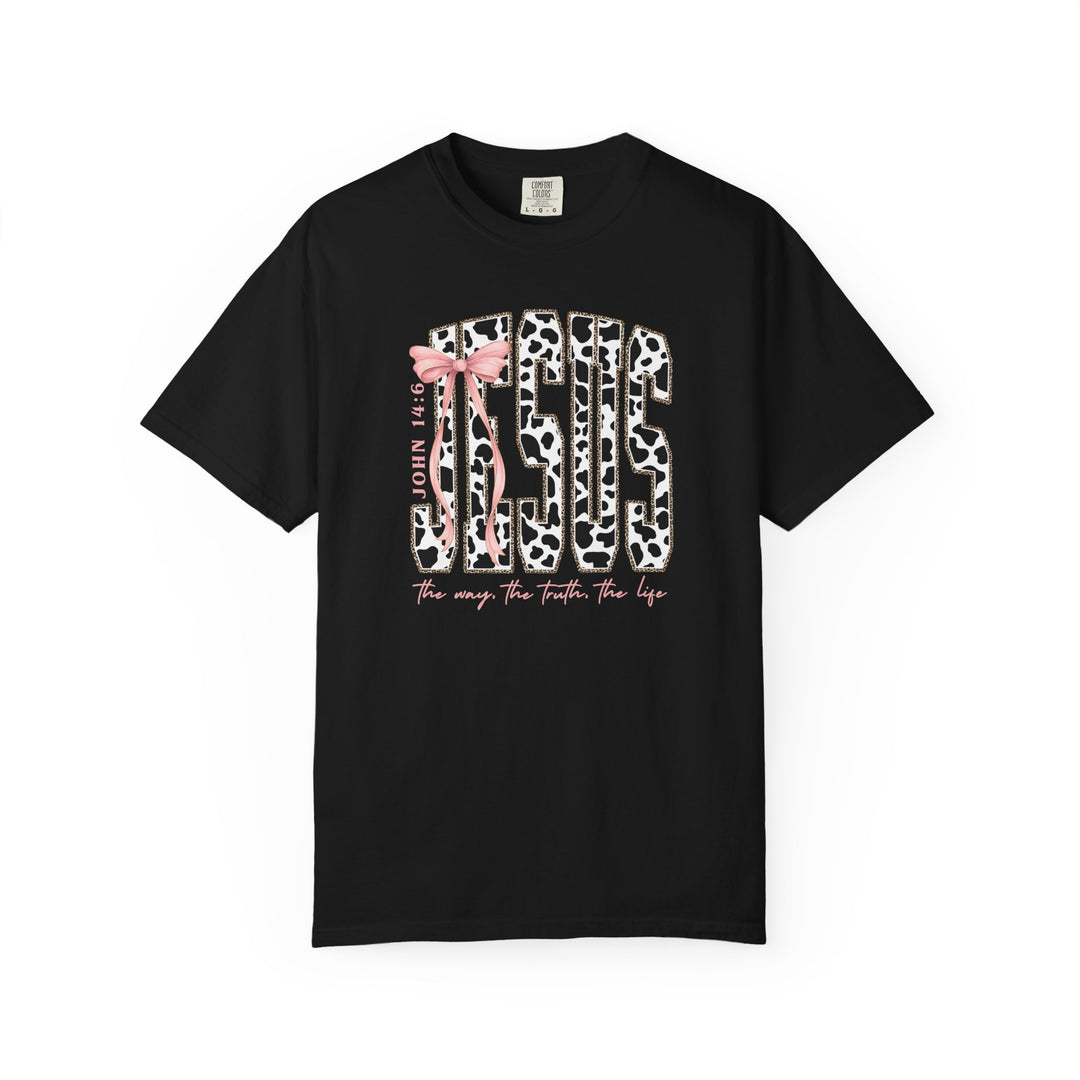 Black T-shirt featuring “JESUS” in cow-print with a pink bow, “JOHN 14:6” nearby, and “the way. the truth. the life.” below.