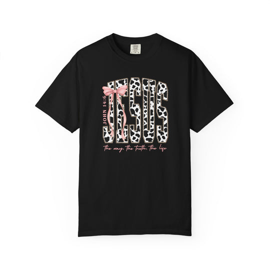 Black T-shirt featuring “JESUS” in cow-print with a pink bow, “JOHN 14:6” nearby, and “the way. the truth. the life.” below.