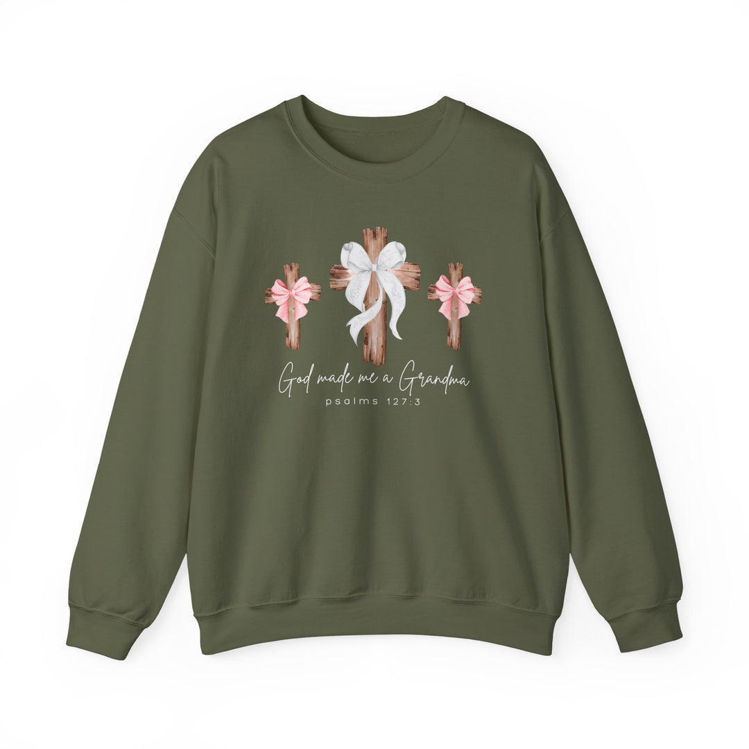 Olive-green crewneck sweatshirt, God Made Me a Grandma, with wooden crosses and scripture reference, perfect comfort blend of polyester and cotton from Faith Family Designs.