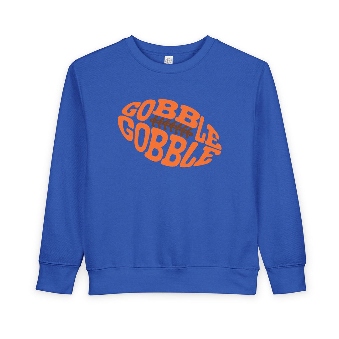 Gobble Football Toddler Crew: Blue sweatshirt with GOBBLE GOBBLE orange football graphic, made from soft cotton-poly blend, perfect for keeping toddlers warm and stylish.