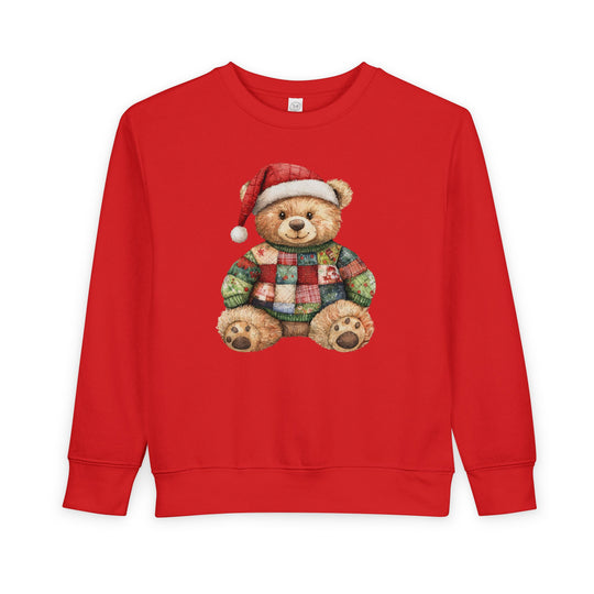 Christmas Bear Toddler Crew: Red crew-neck sweatshirt with teddy bear in Santa hat, wearing a festive patchwork sweater. Cozy, durable cotton-polyester blend for toddlers.