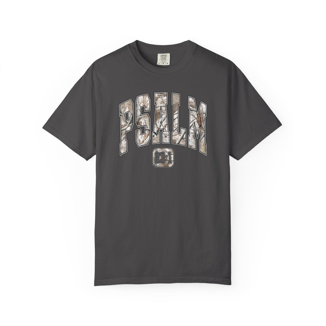 Camo Psalm 23 Tee featuring a woodland-patterned PSALM and 23:1 reference on a dark charcoal short-sleeve T-shirt, offering unique style and biblical inspiration.