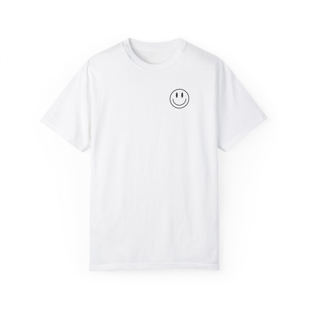 A white t-shirt featuring a smiley face graphic, the God Day to Have a Good Day Tee from Worlds Worst Tees. Made of 100% ring-spun cotton, garment-dyed for coziness, with a relaxed fit and durable double-needle stitching.