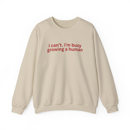 Light-cream crewneck sweatshirt with red text i can’t. i’m busy growing a human on front, designed for comfort and durability.