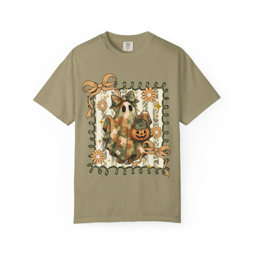 Quilted Ghost Tee features a ghost with a patchwork sheet and bow, holding a jack-o-lantern, framed by curly vines and flowers.