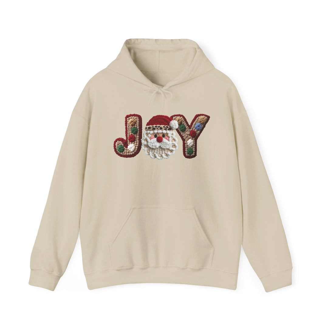 Cream-colored hoodie with JOY graphic, featuring a Santa-face motif as the O. Includes kangaroo pocket and matching drawstring. Cozy cotton-polyester blend.