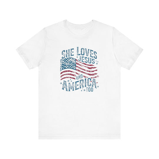 White crew-neck T-shirt with distressed American flag graphic and slogan She Loves Jesus and America Too, reflecting Faith Family Designs' unique, patriotic style.