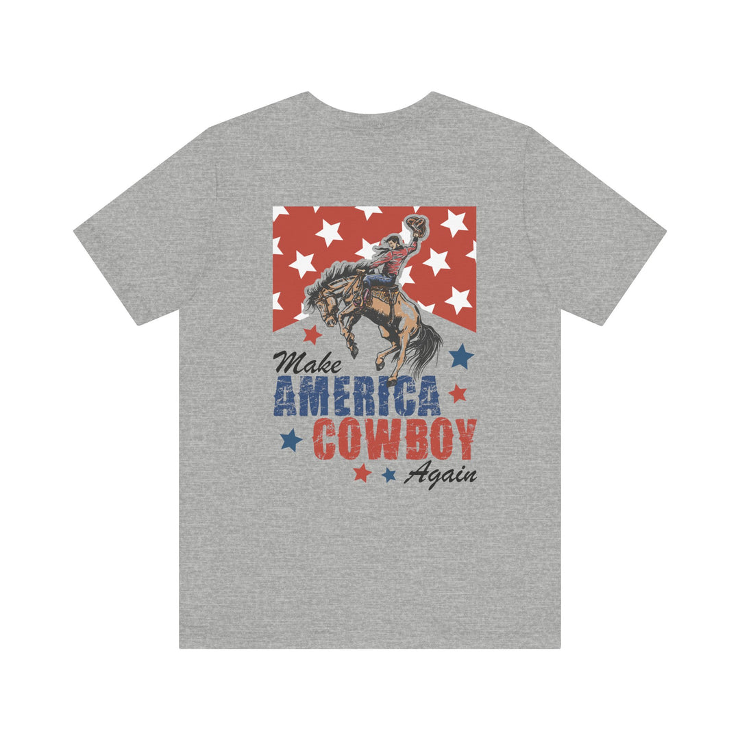 Heather-gray T-shirt featuring a Western motif with Make America Cowboy Again in distressed lettering, showcasing a bucking horse and rider, from Faith Family Designs.