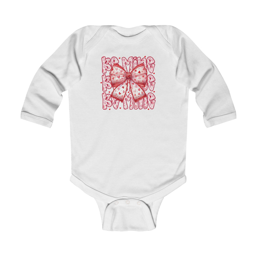 Be Mine Onesie: White infant bodysuit featuring a pink bow with heart patterns and Be Mine text, designed for comfort with 100% cotton and easy-change snaps.