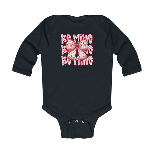Be Mine Onesie: Navy long-sleeved infant bodysuit featuring a pink heart-patterned bow and Be Mine text, with snap closures for easy changing.