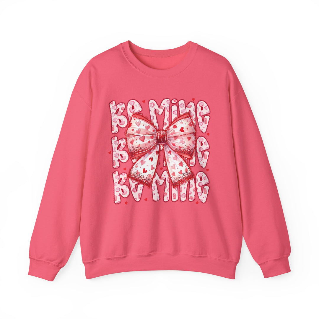 Be Mine Crew sweatshirt with a heart-patterned bow design, embodying Valentine’s Day charm, made from a comfortable polyester-cotton blend with ribbed collar.