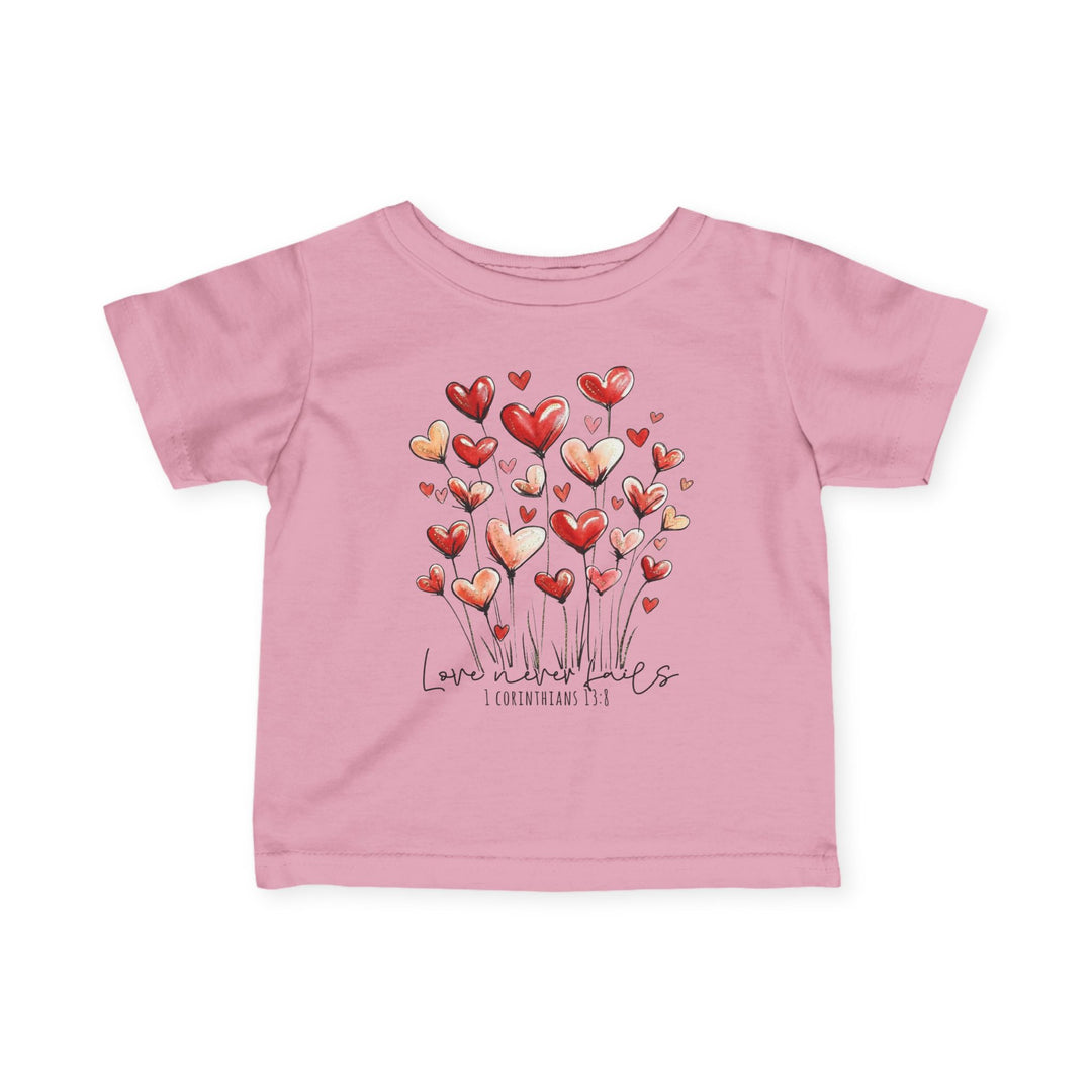 Pink toddler T-shirt with heart bouquet graphic, Love never fails script, and 1 Corinthians 13:8 reference, designed for comfort and durability.