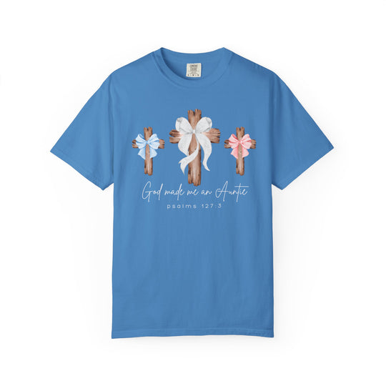 Light-blue God Made Me an Auntie tee with rustic crosses and bows, crafted from soft-washed, garment-dyed cotton for comfort and durability.